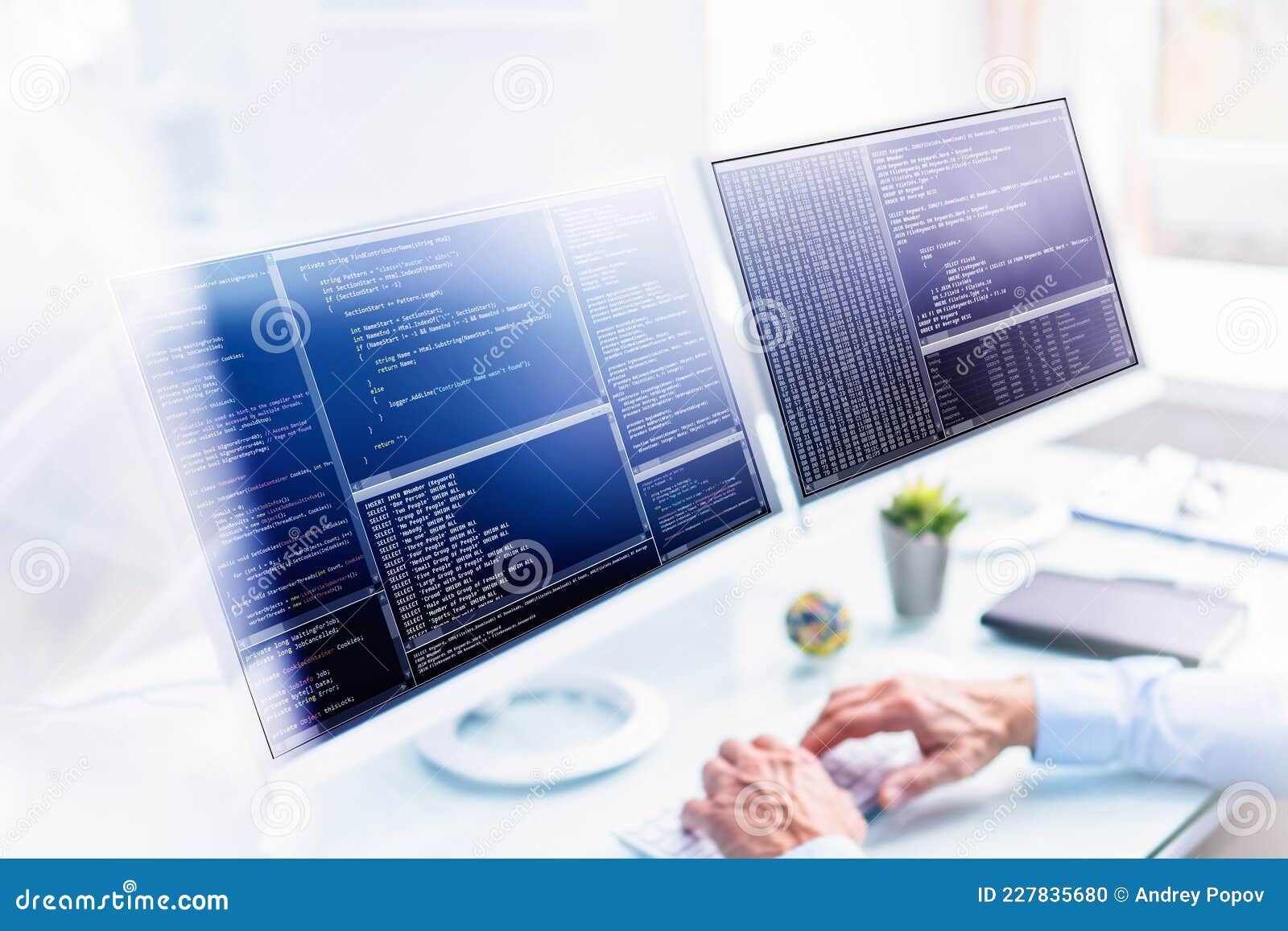 Computer Programmer Using Multiple Monitor Screens Stock Photo - Image ...