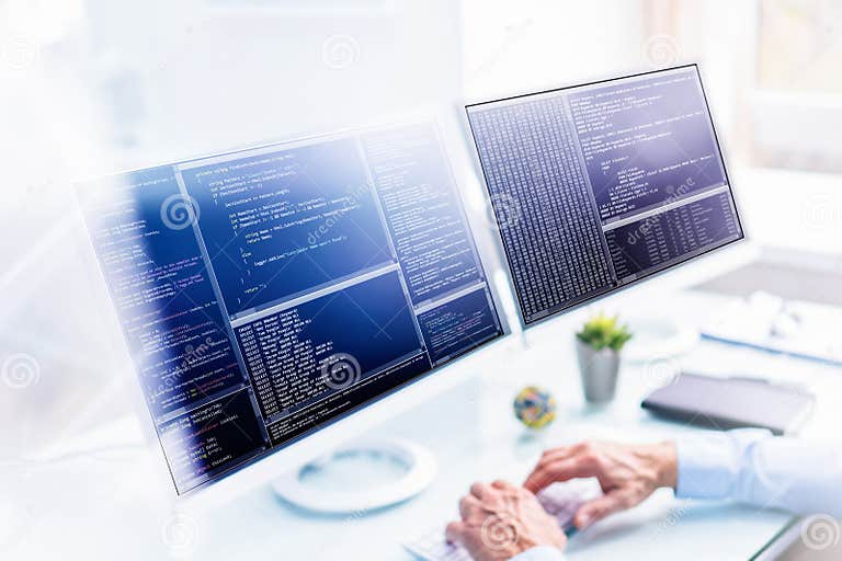 Computer Programmer Using Multiple Monitor Screens Stock Photo - Image ...
