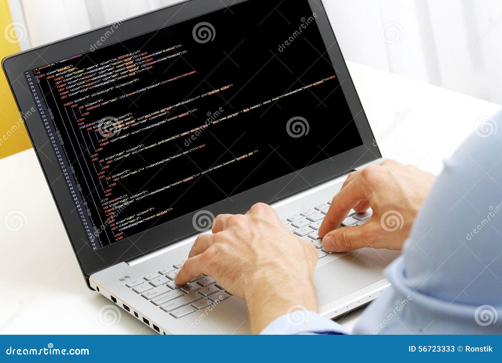 programmer profession - man writing programming code on laptop