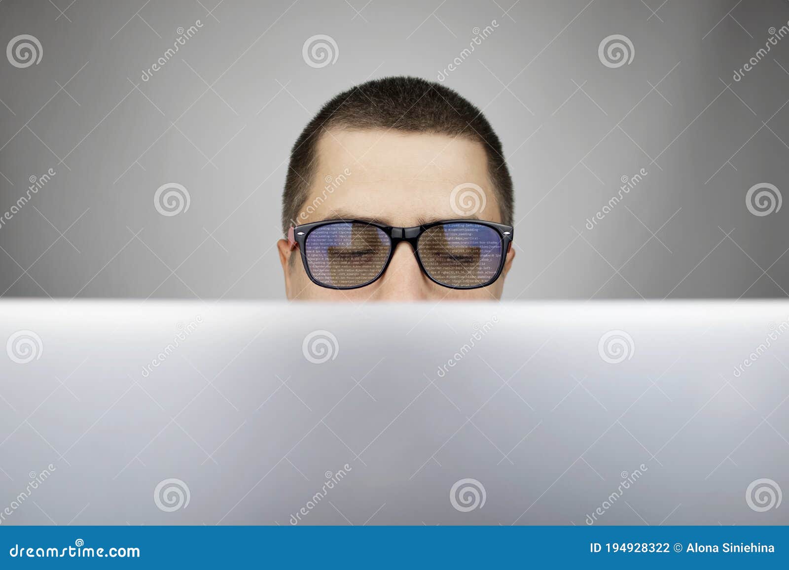 the programmer`s glasses reflect lines of code. programming, development of applications, sites and other things. software