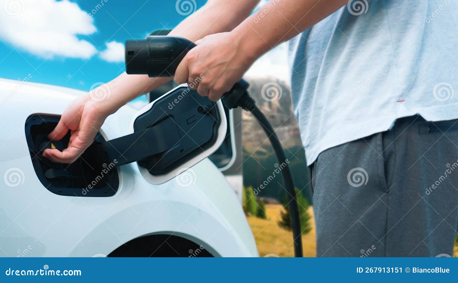 Progressive Man Recharge EV Car from Charging Point in Rural Mountain