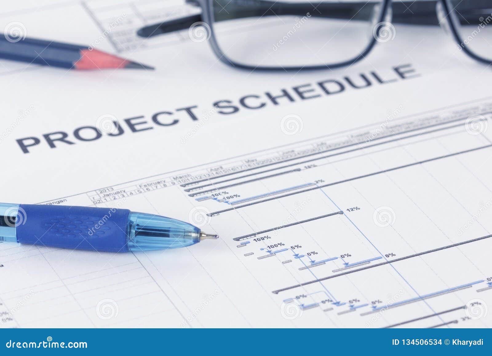 project schedule document with pen, pencil, eyeglases and gantt chart