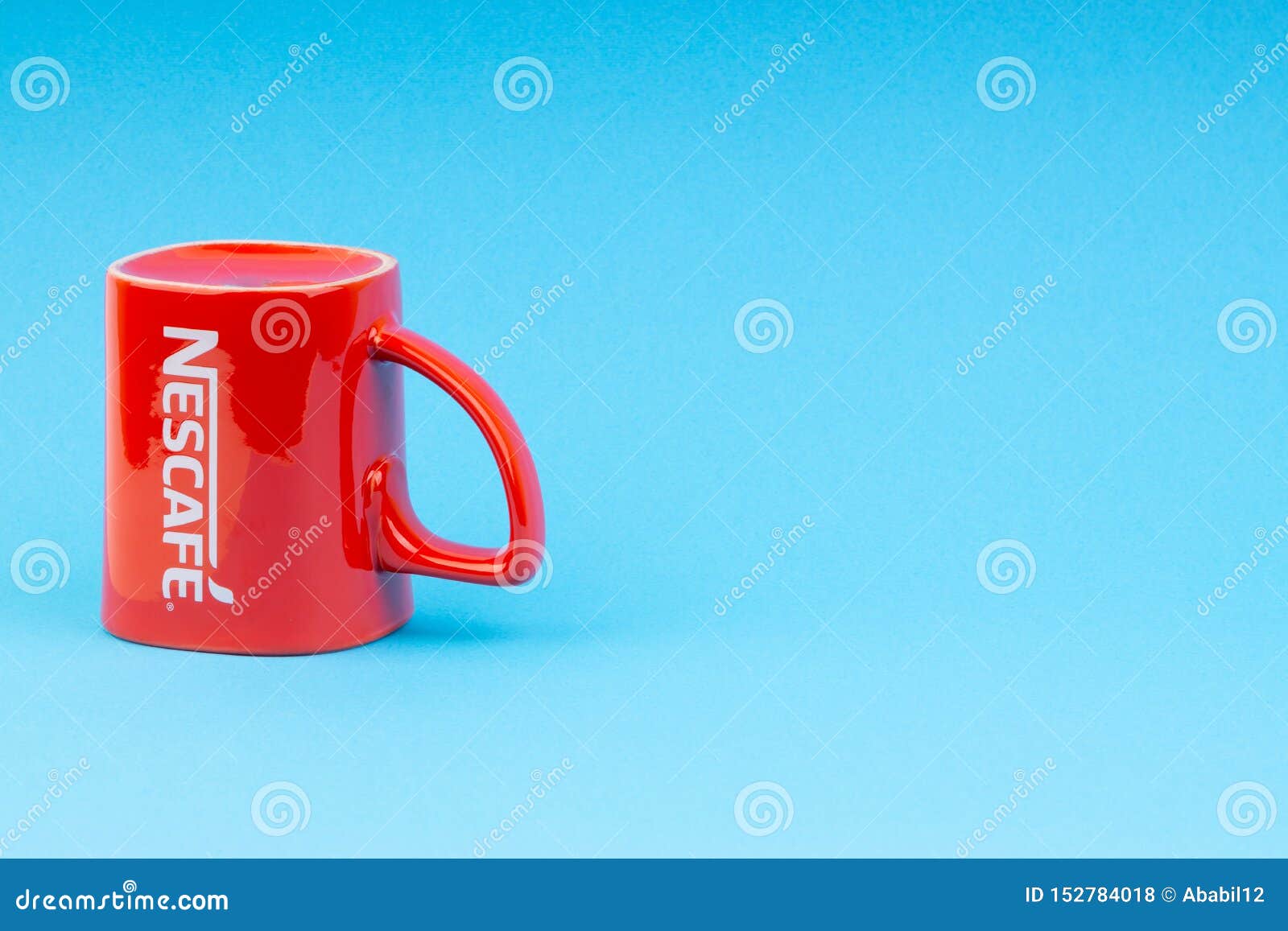 Promotional Red Nescafe Mug On Blue Background Editorial