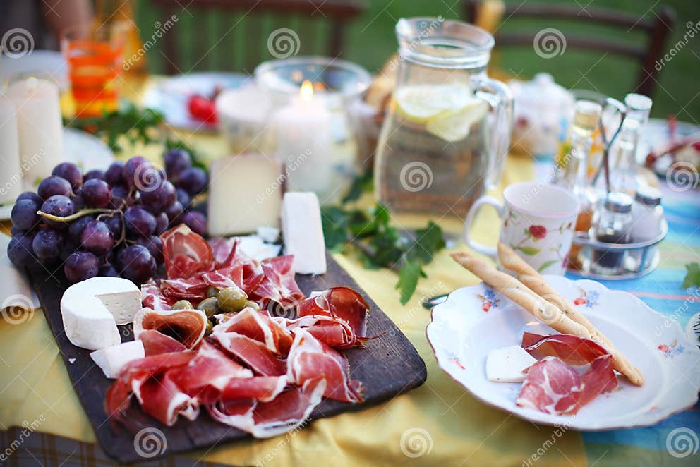 Prosciutto with Cheese and Grapes on a Picnic Table Stock Image Image