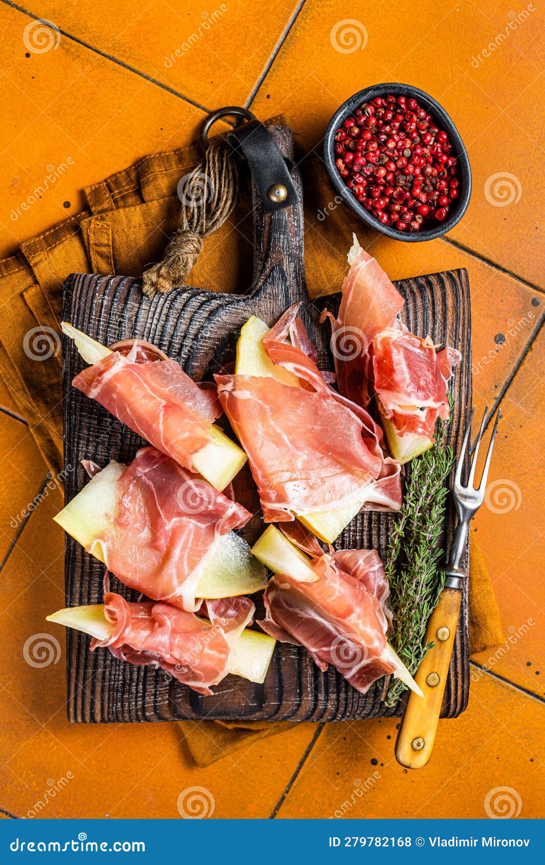Prosciutto Ham with Slices of Melon and Fresh Thyme. Orange Background Stock Photo Image of