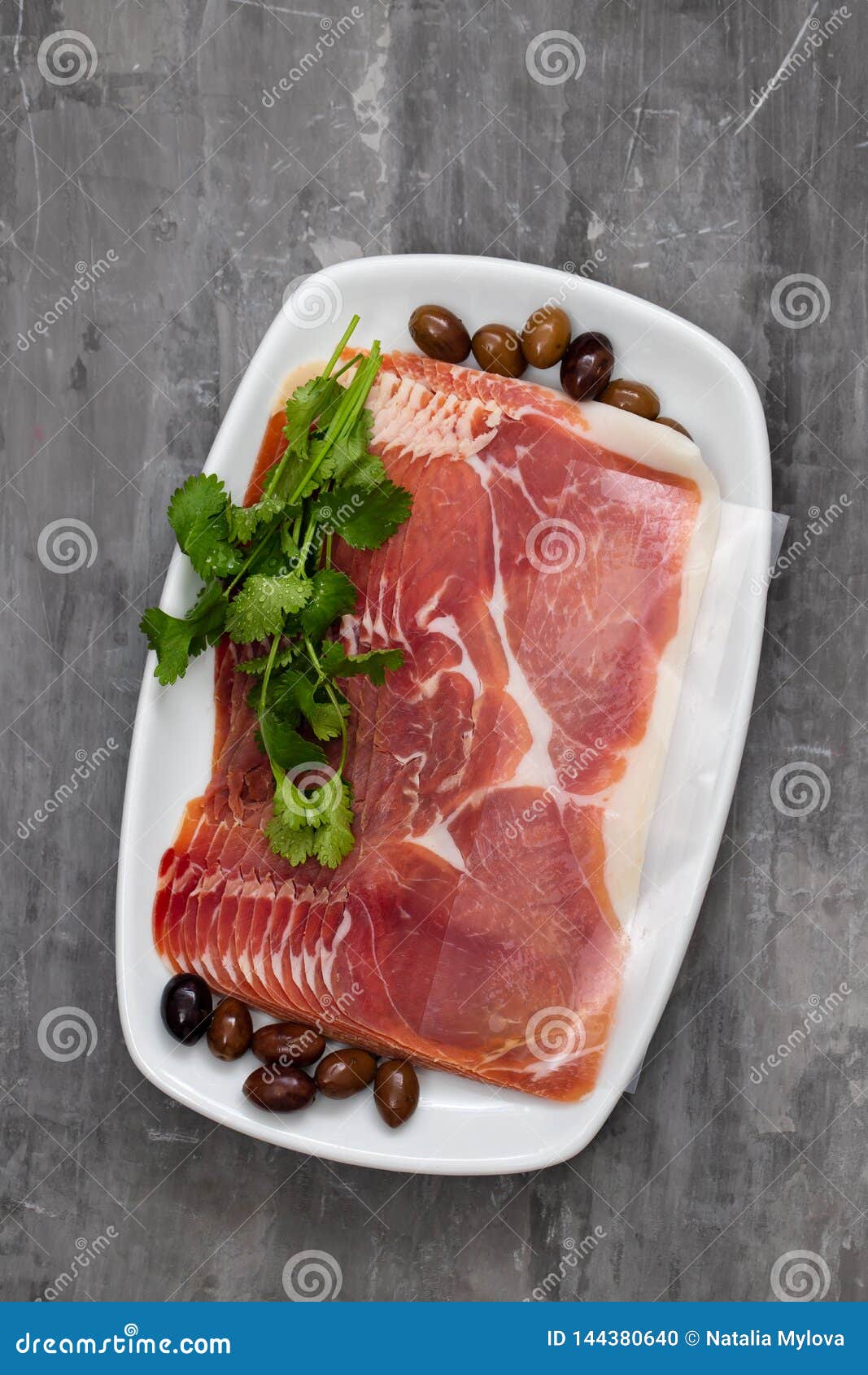 Prosciutto with Olives and Parsley on White Dish on Ceramic Background Stock Photo Image of