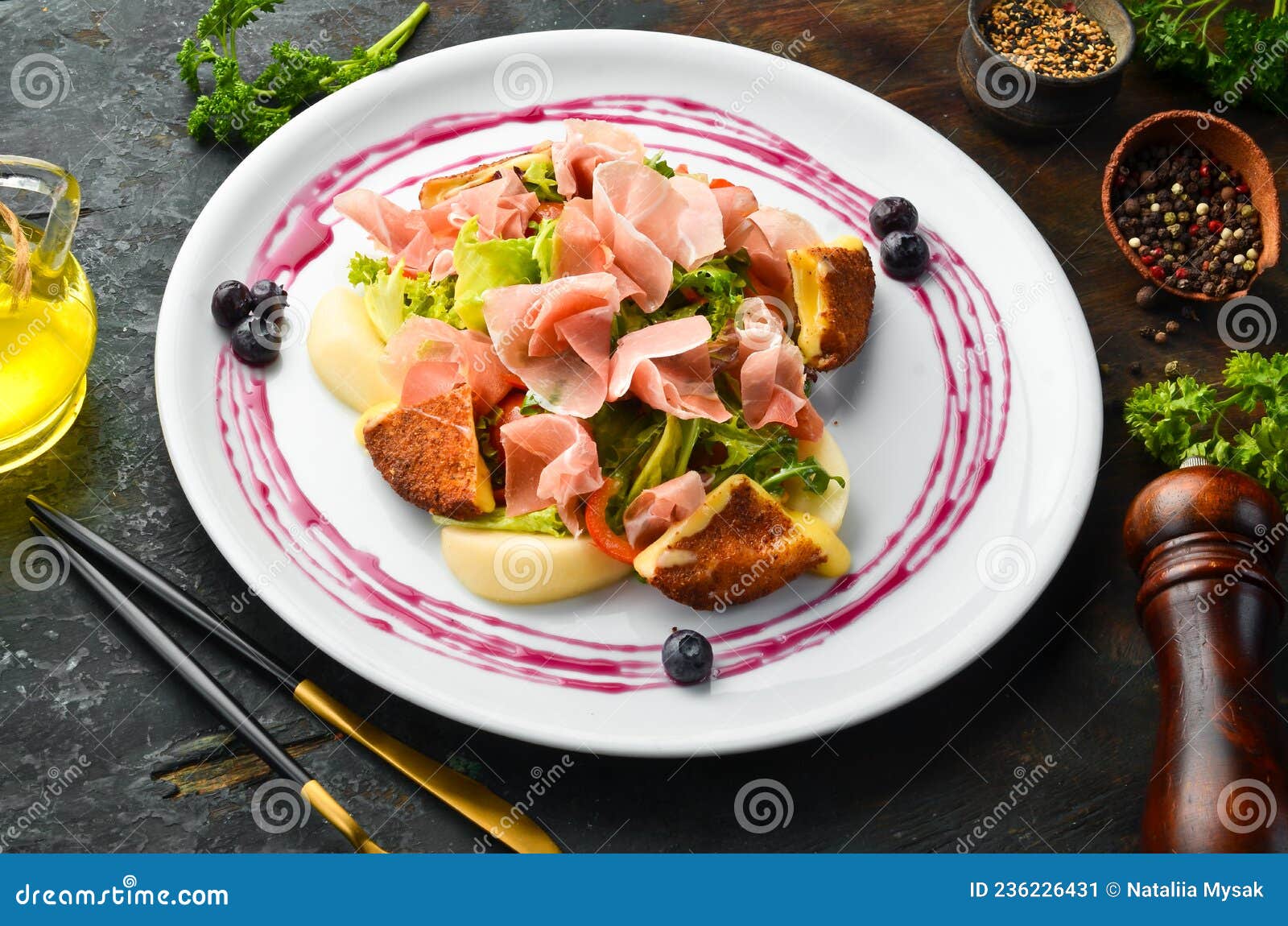 Prosciutto Salad, Brie Cheese and Vegetables on a White Plate. Stock