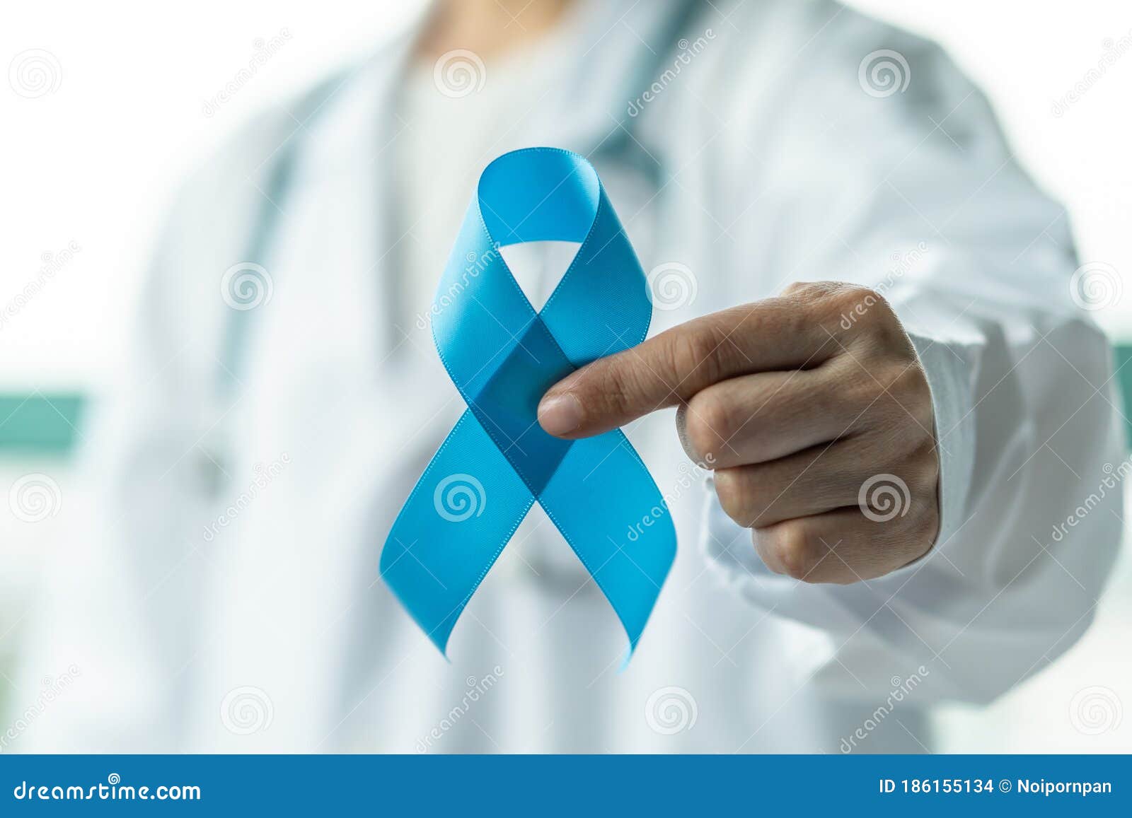 prostate cancer blue awareness ribbon for men health in november with light blue bow color on medical doctorÃ¢â¬â¢s hand in clinical