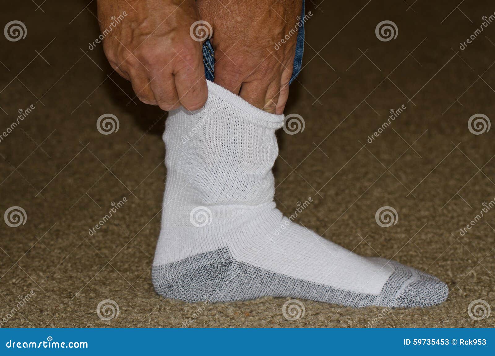Protecting Against Ticks by Tucking Pants into Socks Stock Image
