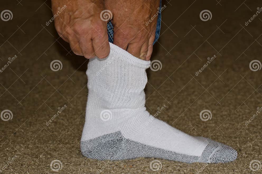 Protecting Against Ticks by Tucking Pants into Socks Stock Image