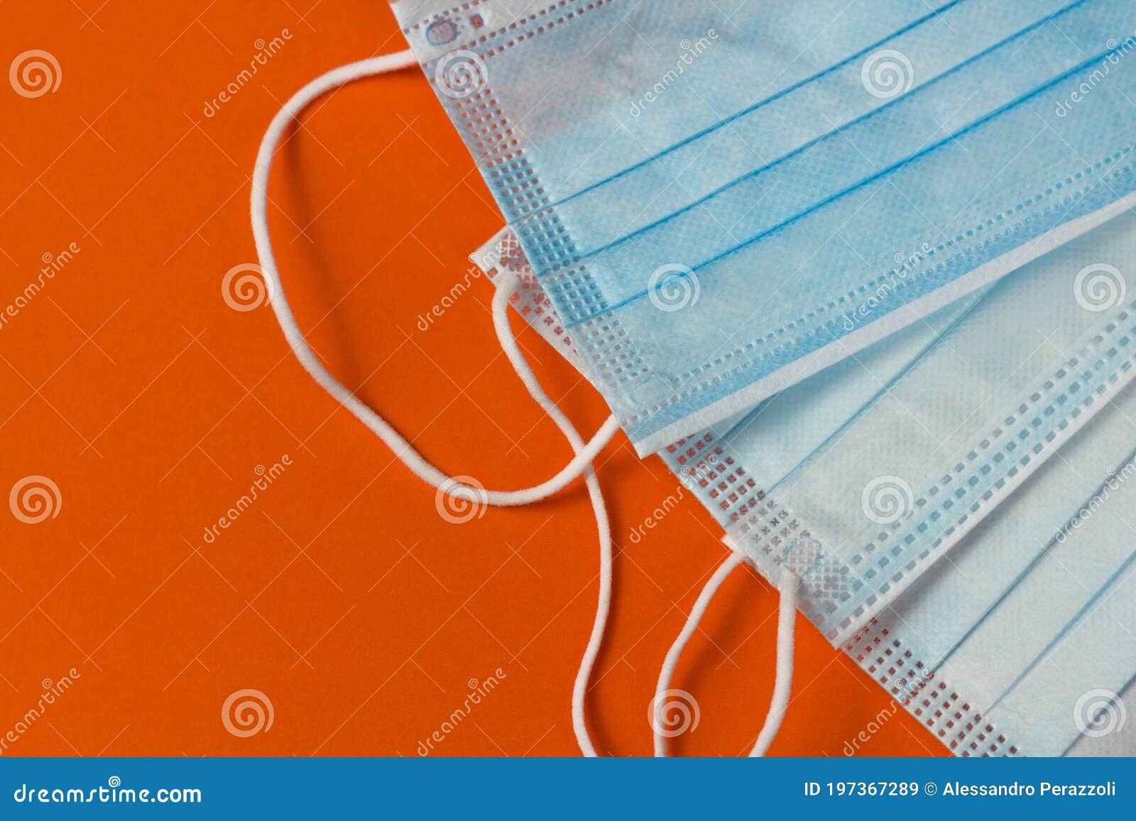 protective medical mask on orange desk.