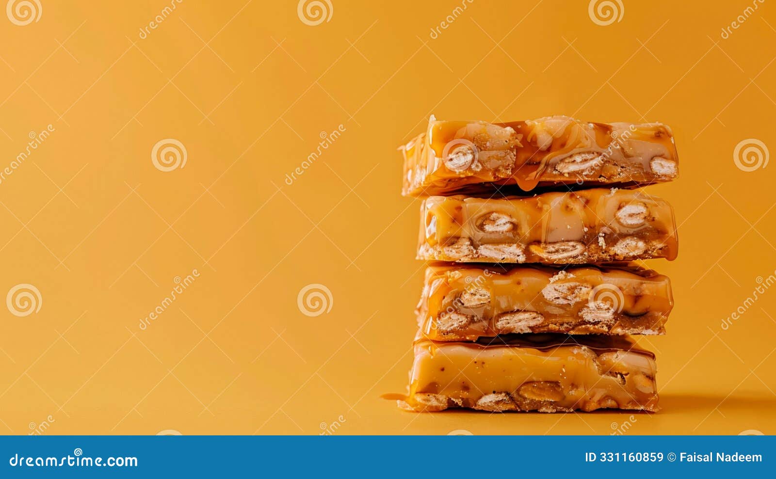 protein bar slices with caramel stacked on each other on orange solid color background, copy space