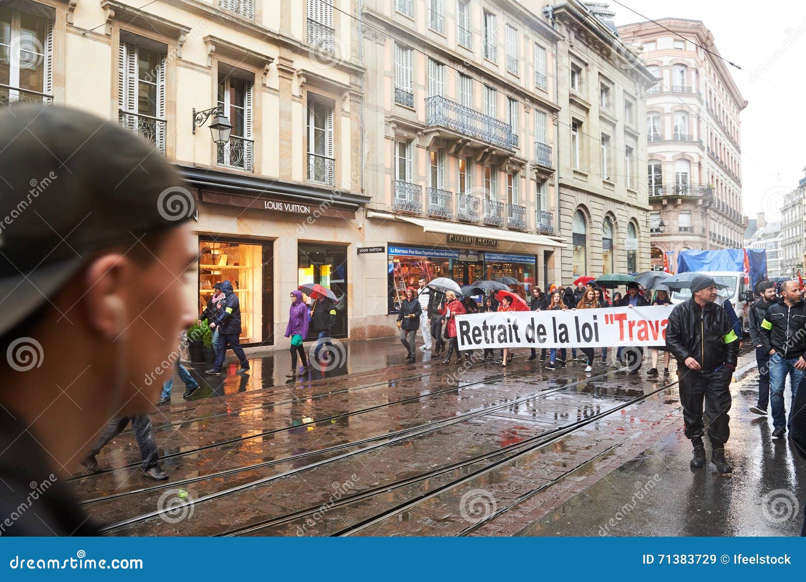 People seen walking past a Louis Vuitton store in the area of