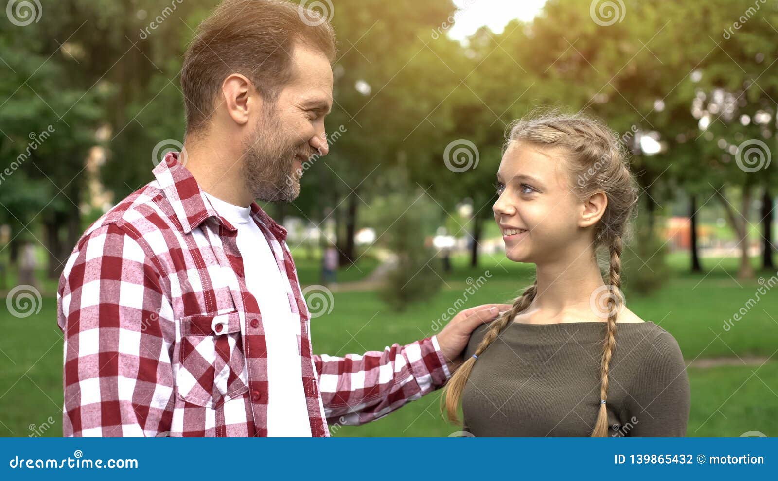 proud father looking at daughter, congratulating with university entry, success