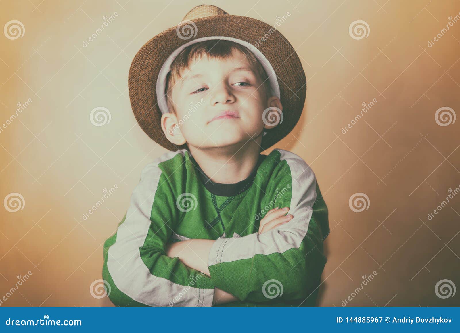 A Proud and Greedy Boy in a Straw Hat with a Haughty Facial Expression ...