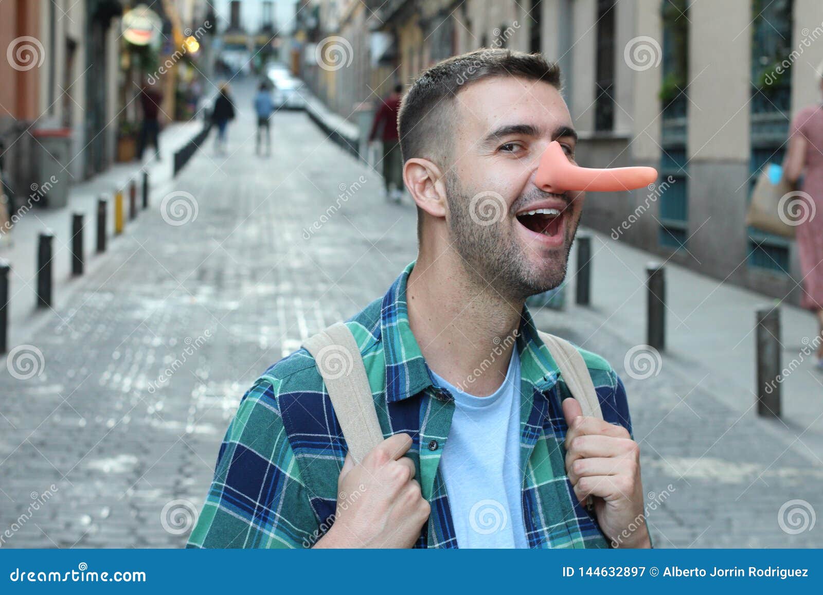 Liar Man With Long Nose Isolated On Grey Wall Background RoyaltyFree