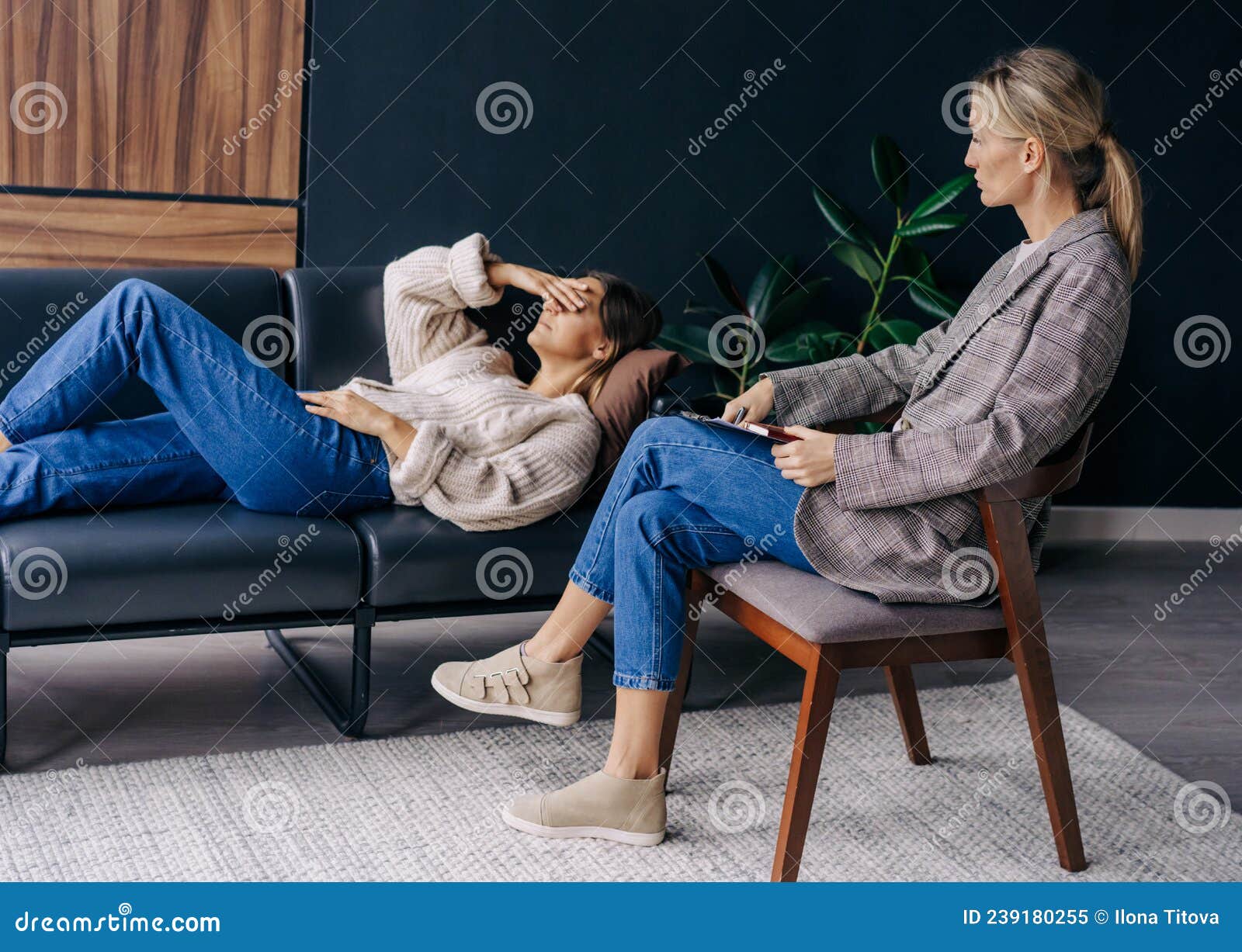 A Psychoanalyst In A Workshop Listens To A Patient Lying On A Couch And 