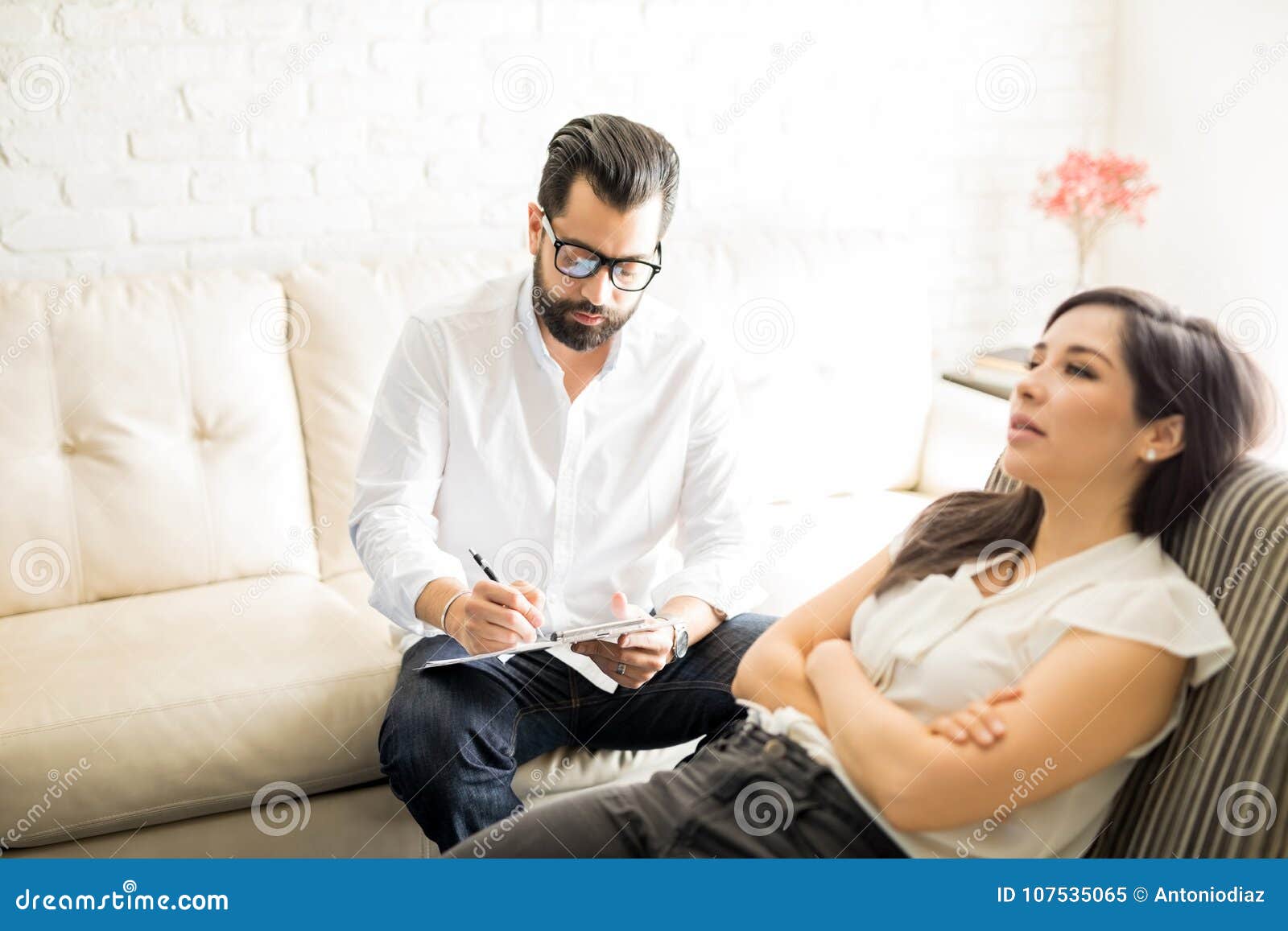 Psychologist Making Notes during Therapy Session with Patient Stock