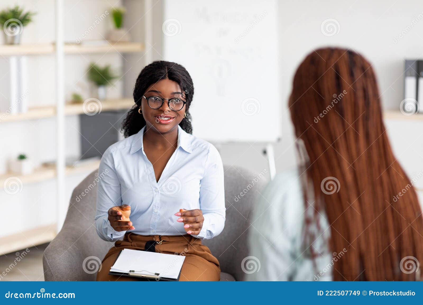 psychotherapy consultation. counselor talking to black woman on meeting at office, giving advice to young client