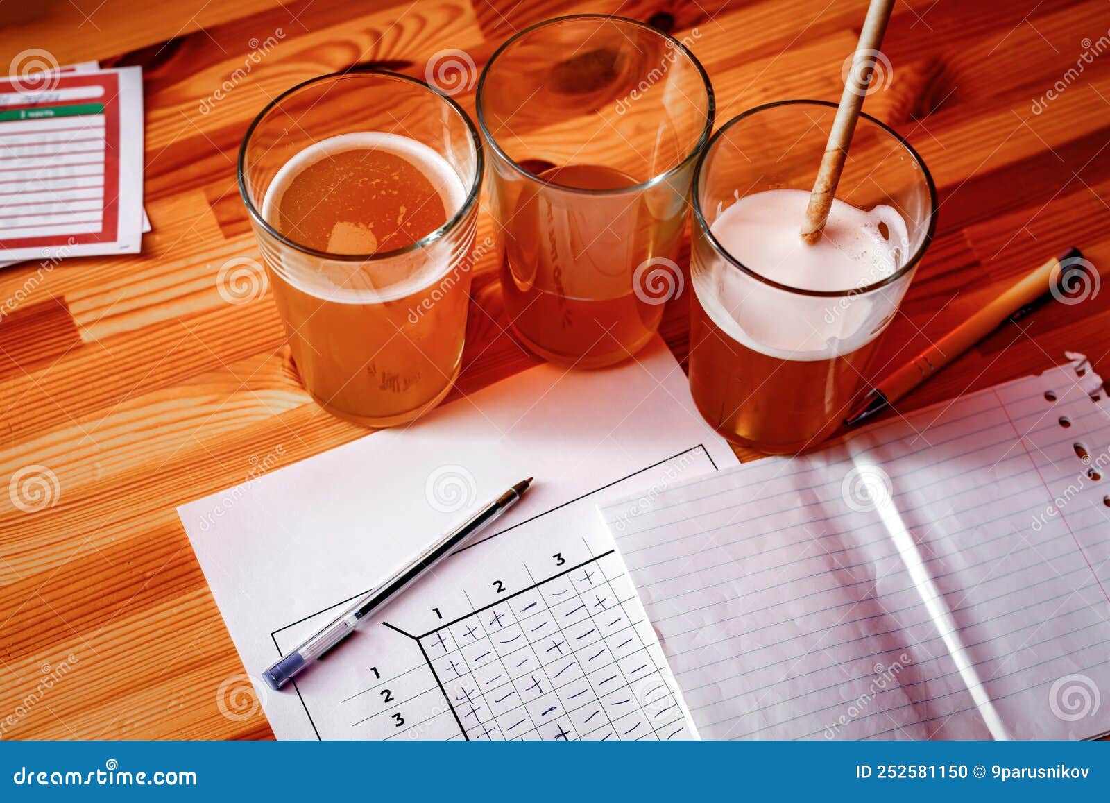 the pub quiz concept. beer glass and blank paper for answers.