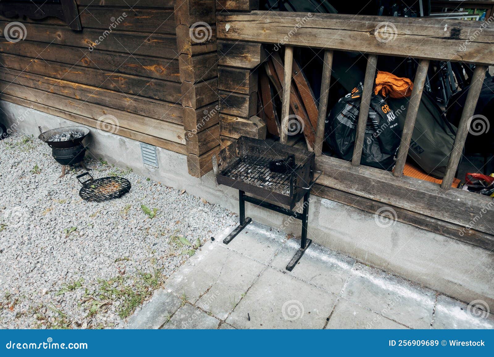 Public Grill and a Coal Pot Captured in a Summer House Backyard Stock