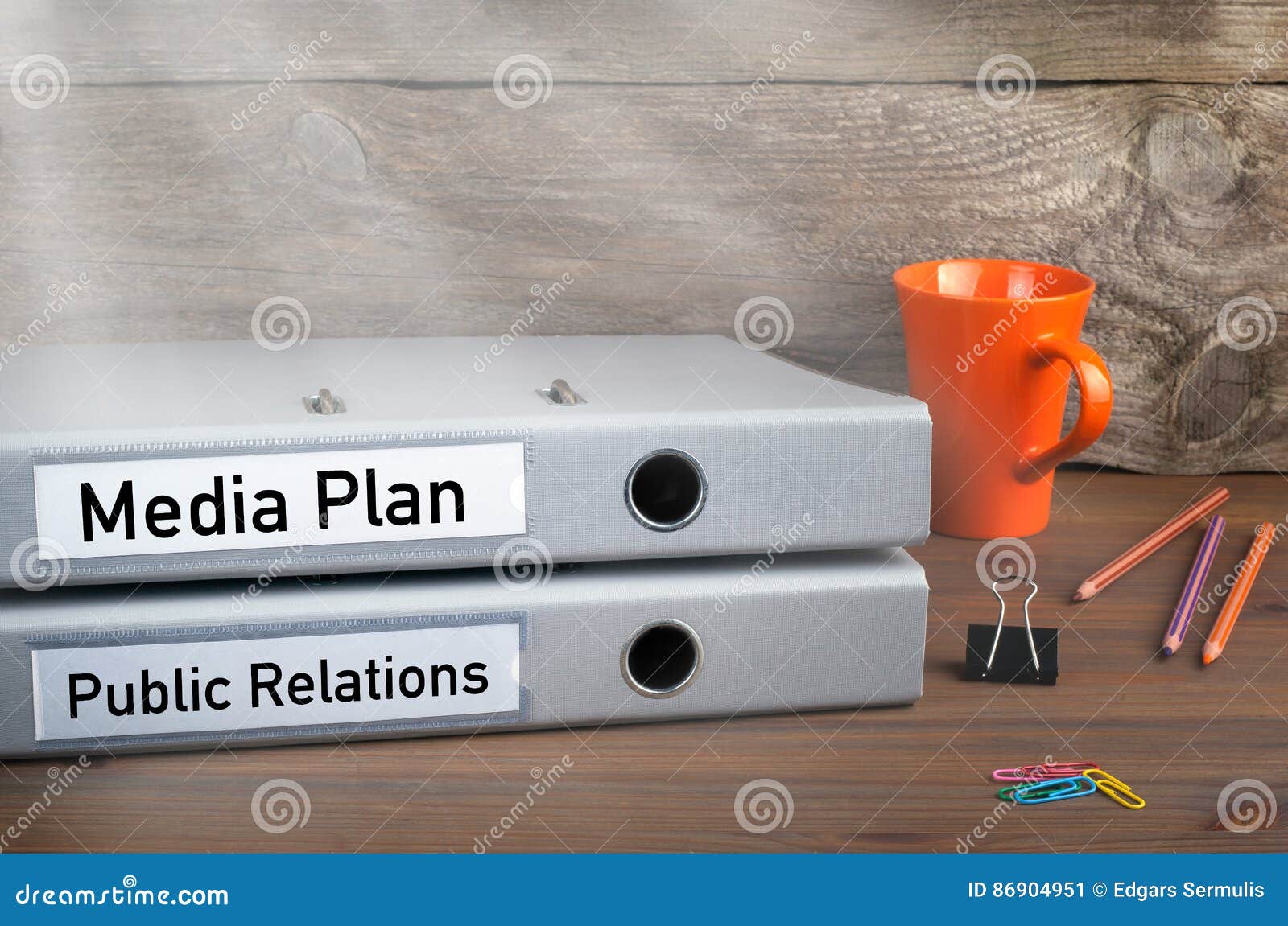 public relations and media plan - two folders on wooden office desk