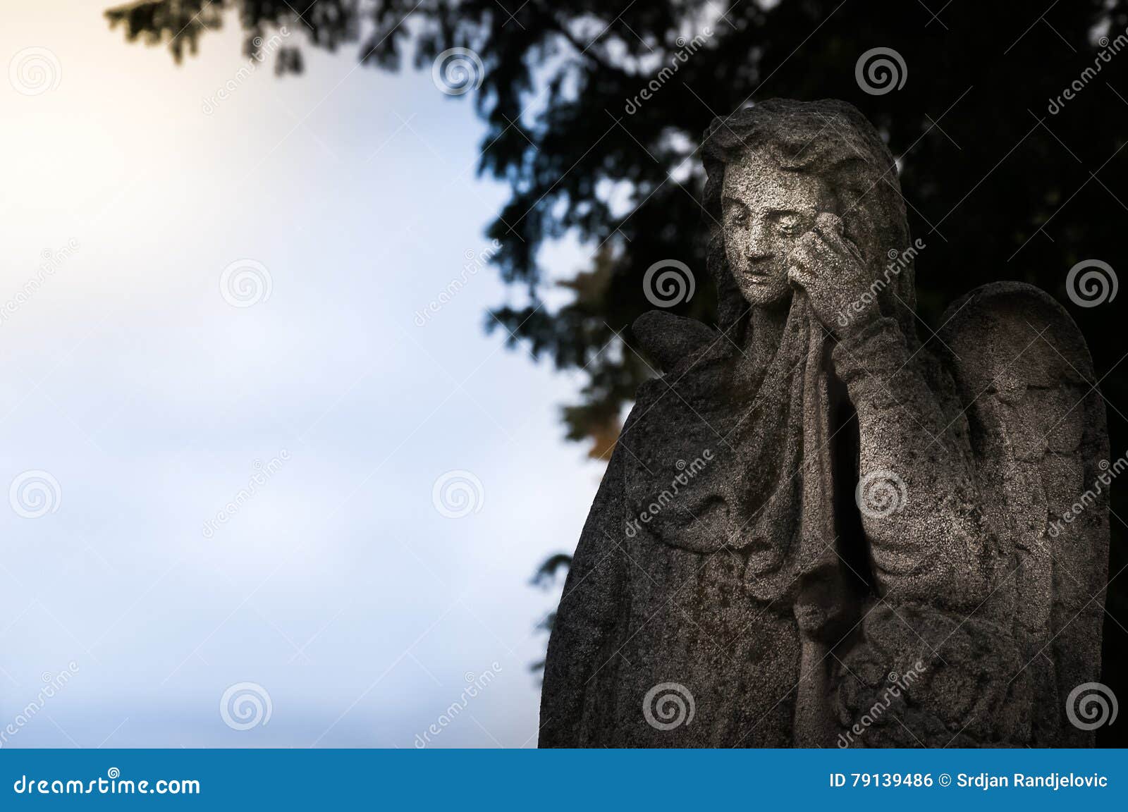 Public Sculpture of Crying Angel in the Cemetery. Stock Photo Image