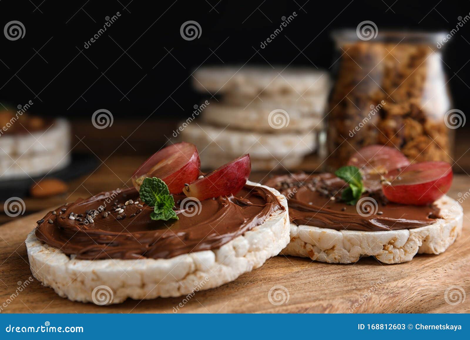 Puffed Rice Cakes with Chocolate Spread and Grape on Board, Closeup