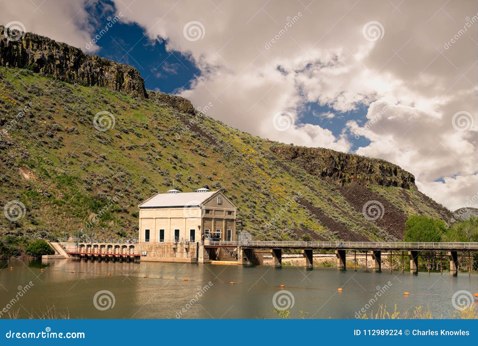 puffy clouds over the diversion dam on the boise river