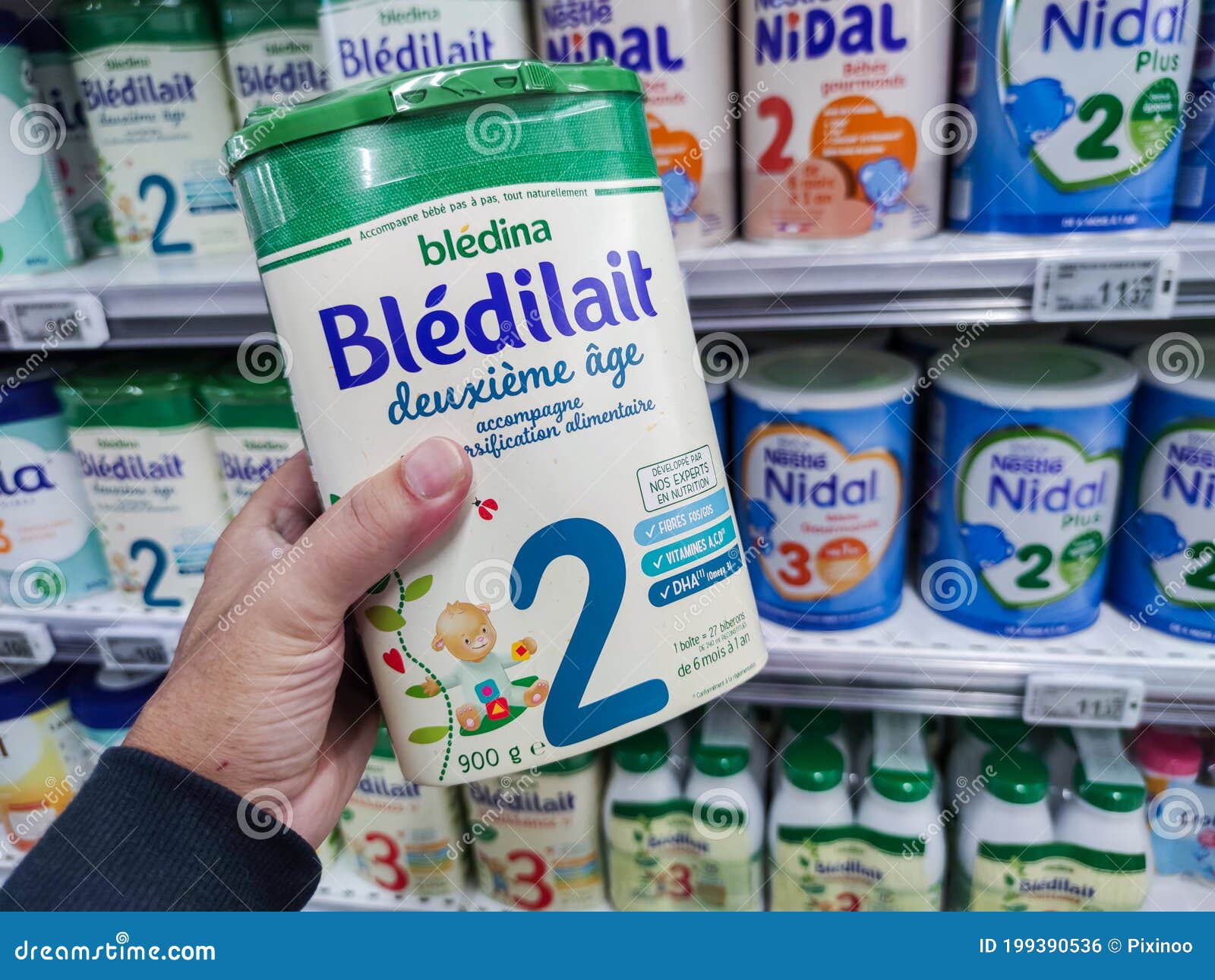 A Consumer Chooses a Box of Bledilait Brand Baby Milk from the