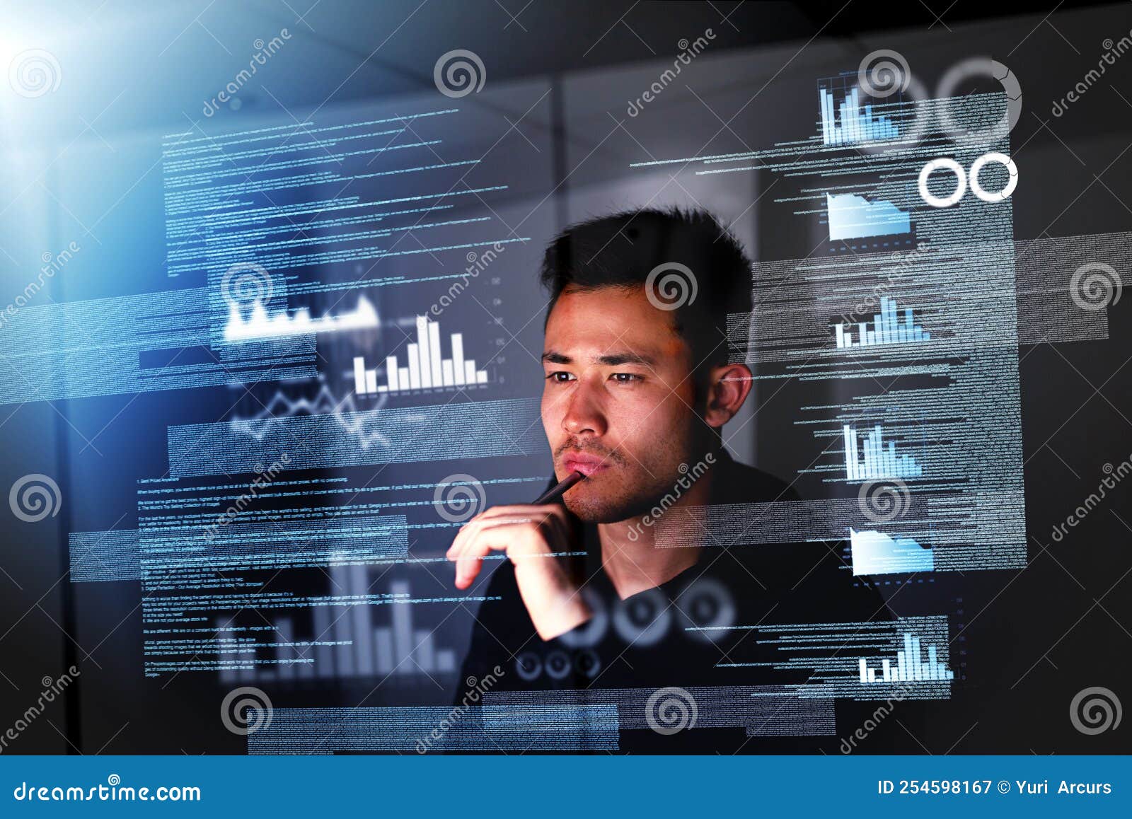 pulling an all nighter. a focussed computer programmer working at his computer late at night.