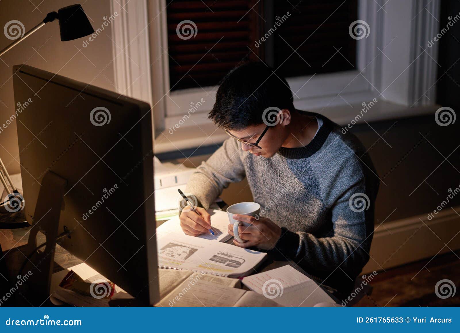 pulling an all nighter. a young student studying late into the night.
