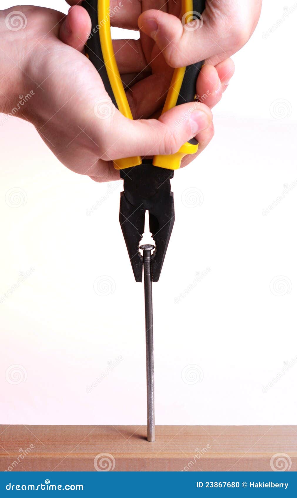Pulling a Nail with Pliers. Stock Photo Image of hand, plank 23867680