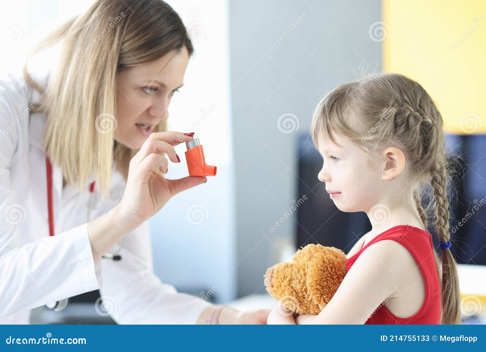 pulmonologist doctor holding hormonal inhaler in front of little girl