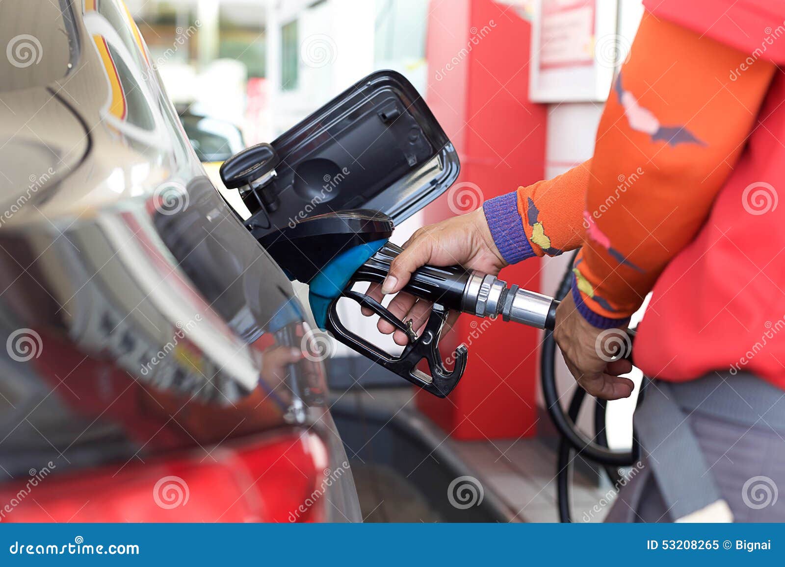 Pumping gas into a car stock image. Image of gasstation 53208265