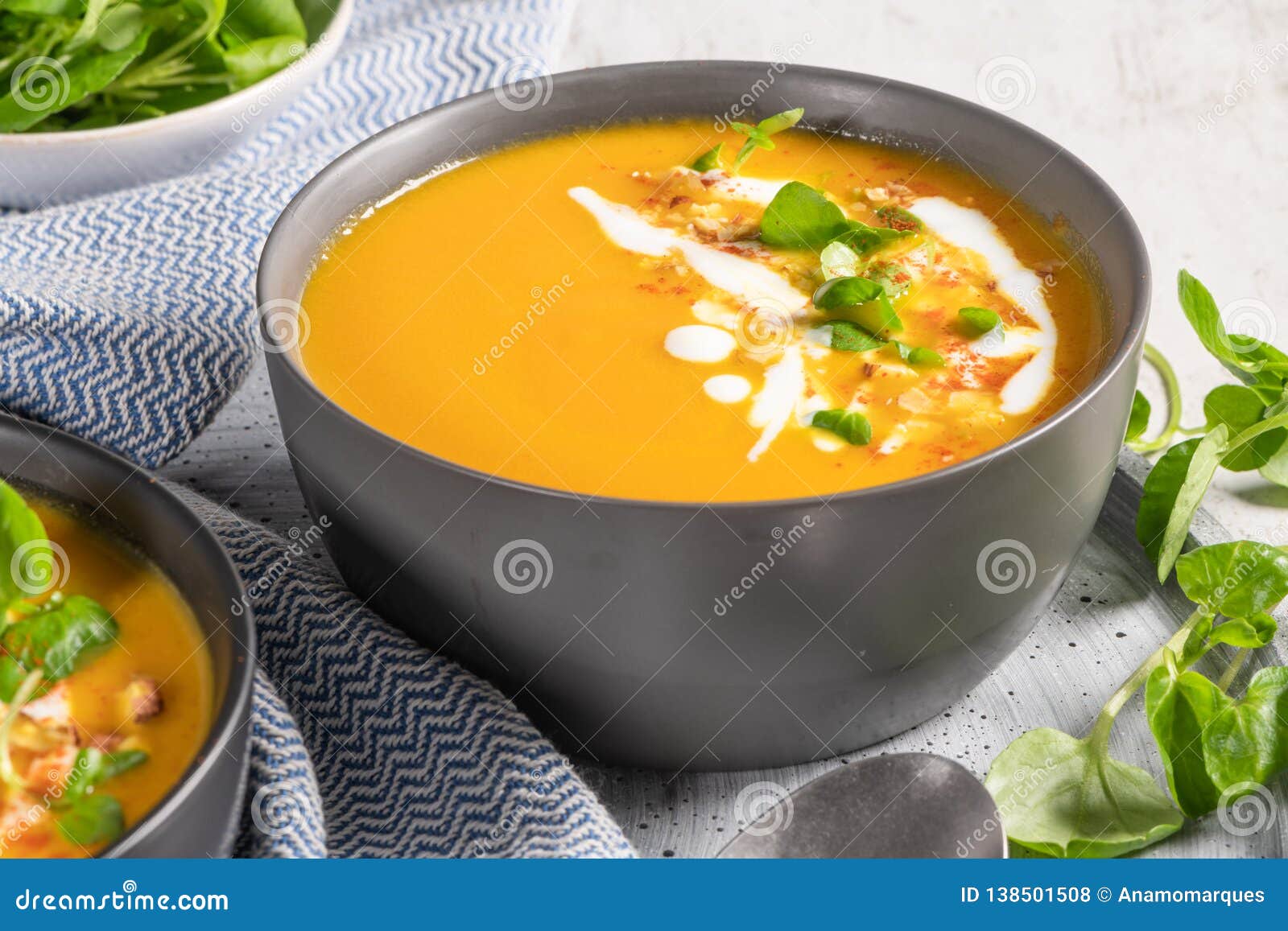 Pumpkin Soup in Bowl Garnished with Cream, Hazelnut and Watercress. Top ...