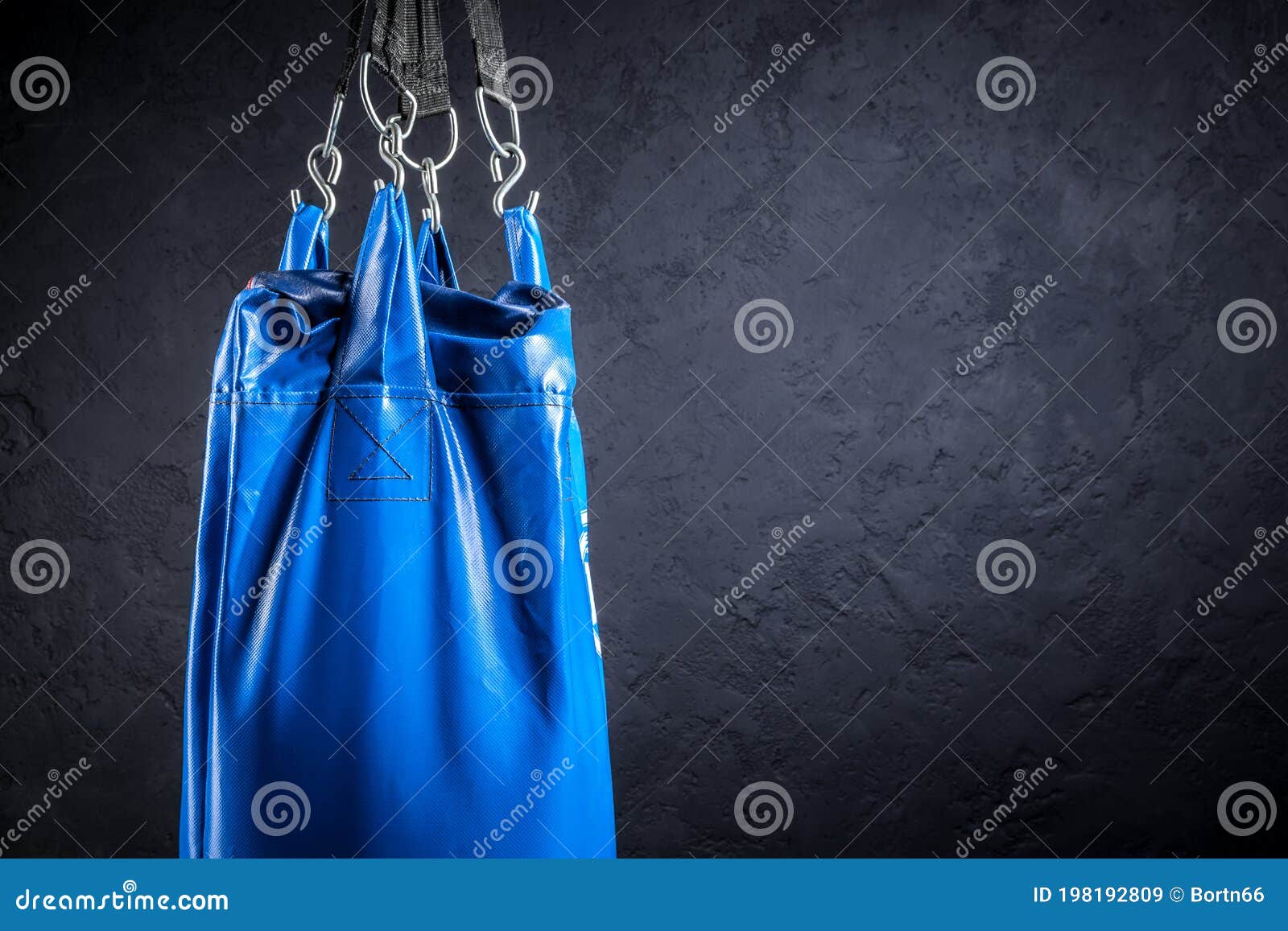 Punching Bag Blue Against a Plastered Wall Stock Image Image of power