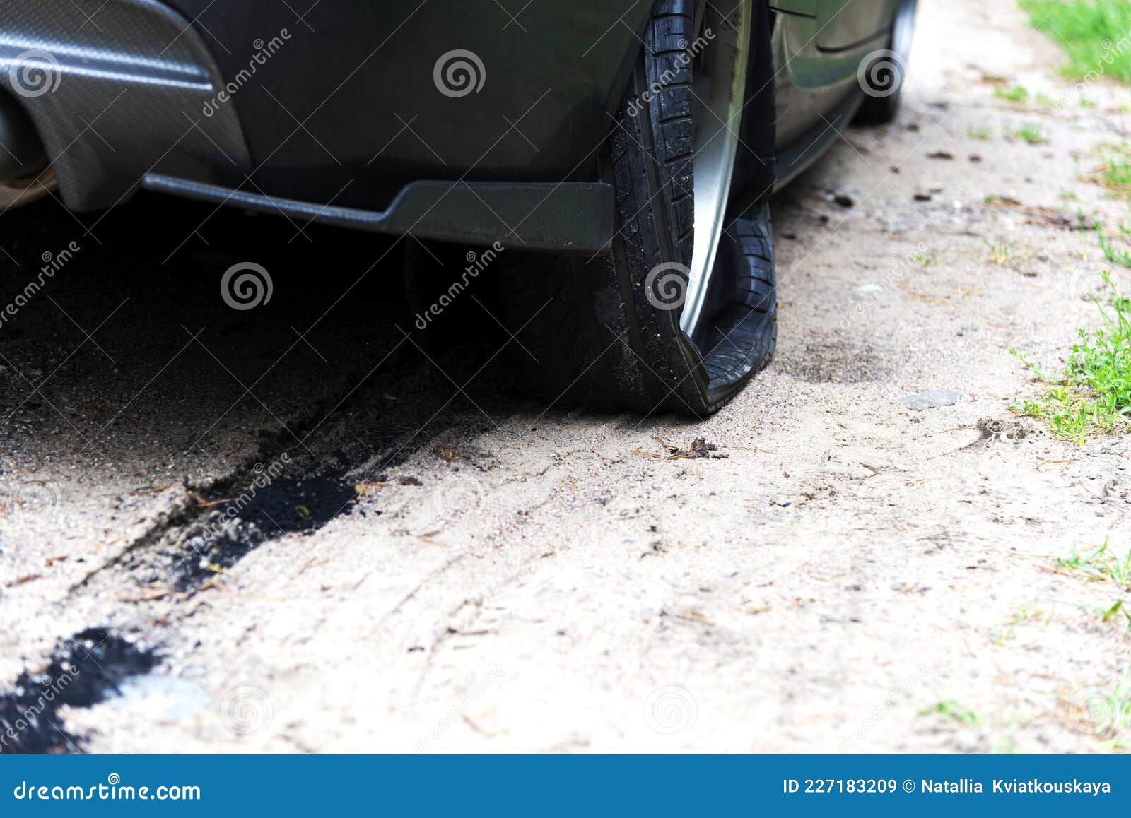 Punctured Wheel of a Modern Car on the Road. Car Tire Puncture Stock