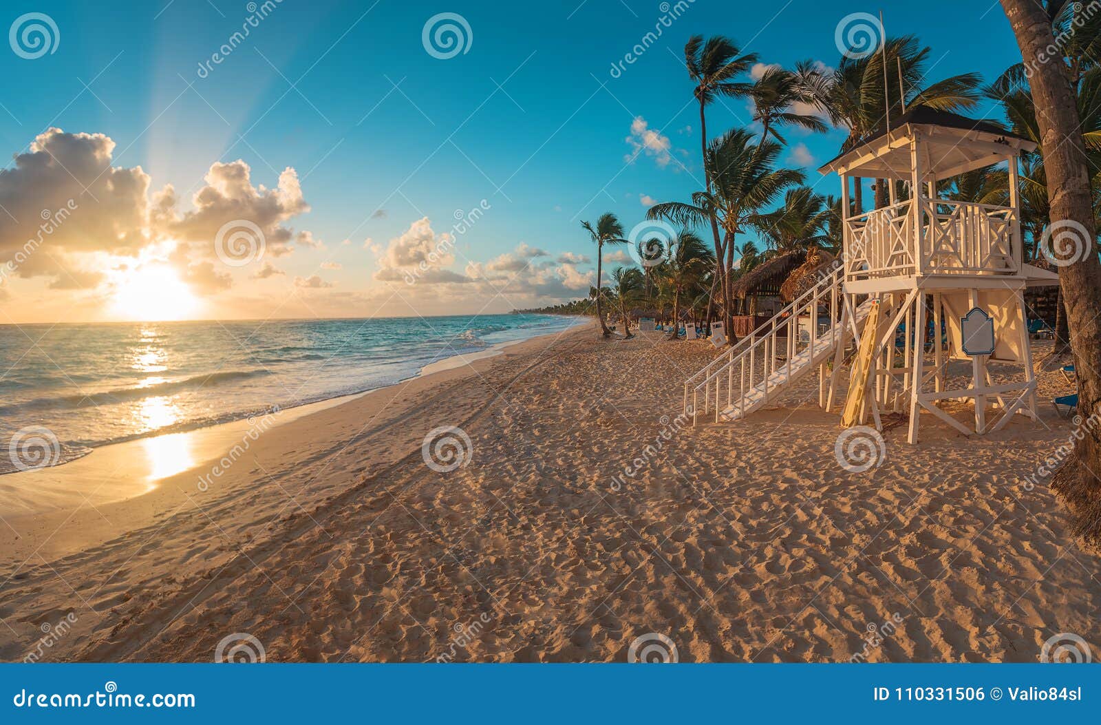 punta cana sunrise over caribbean beach with lifeguard stati
