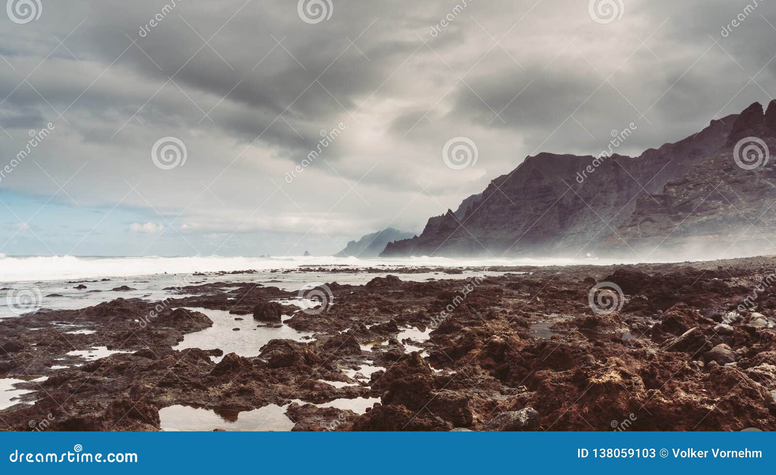 punta del hidalgo, tenerife, espania - october 27, 2018: panorama of the rocky beach of punta de hidalgo and the waves breaking at