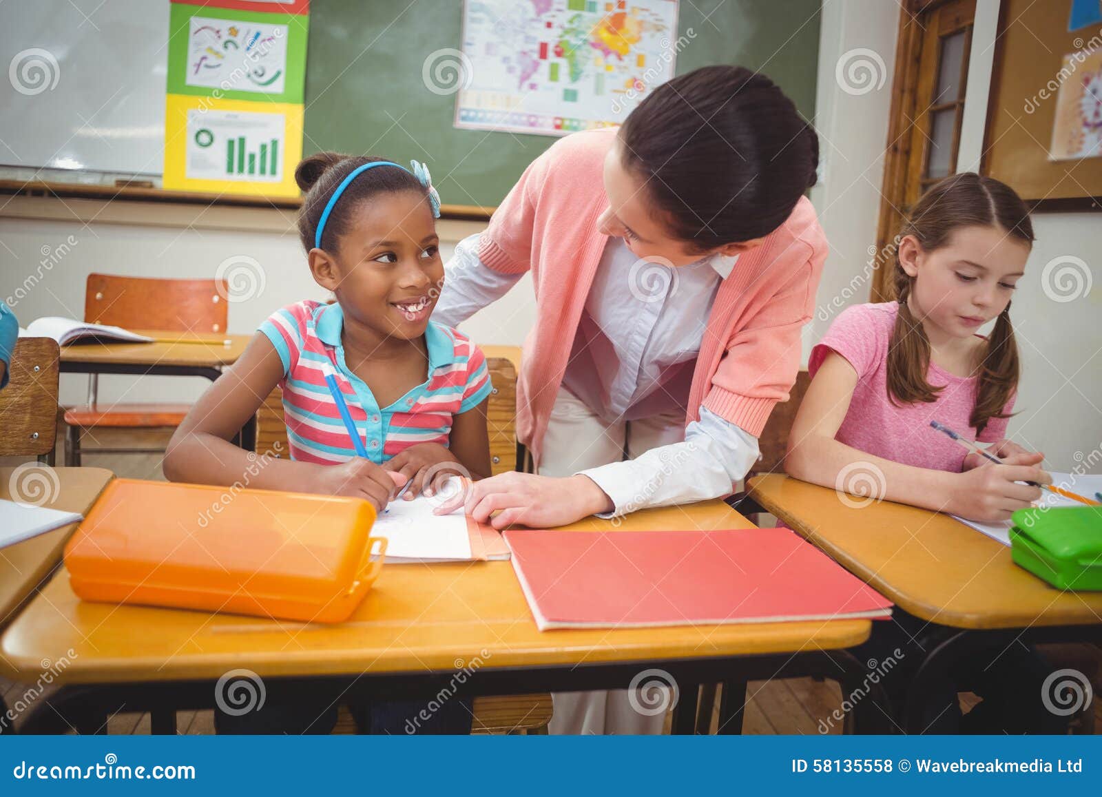 Pupil and Teacher at Desk in Classroom Stock Photo Image of adult