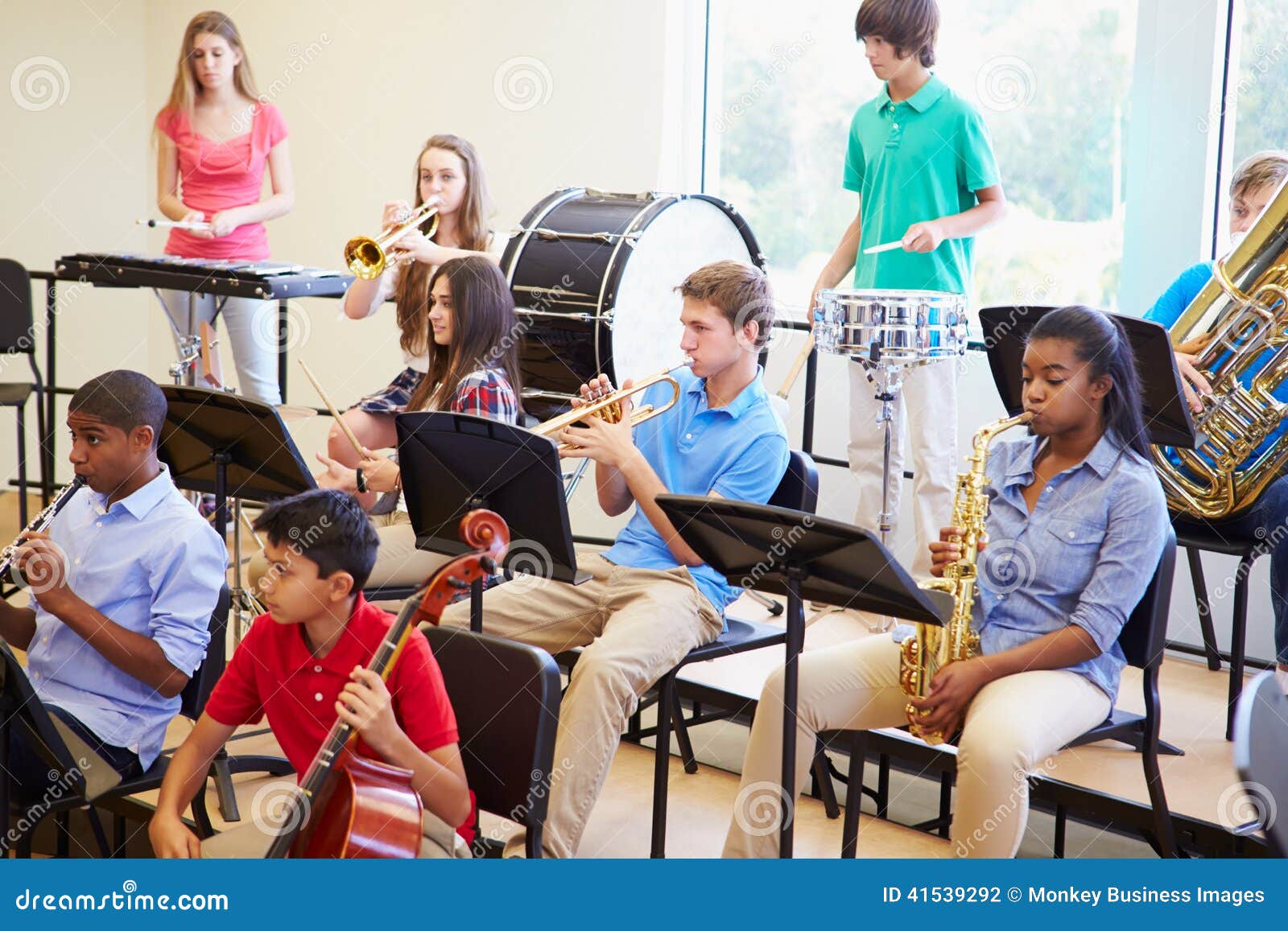 pupils playing musical instruments in school orchestra