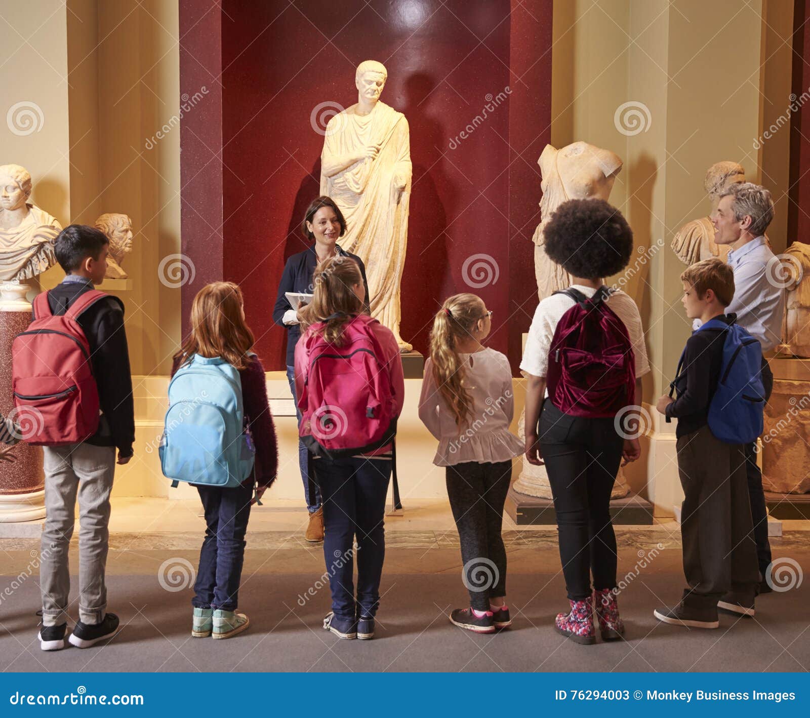 Pupils and Teacher on School Field Trip To Museum with Guide Editorial