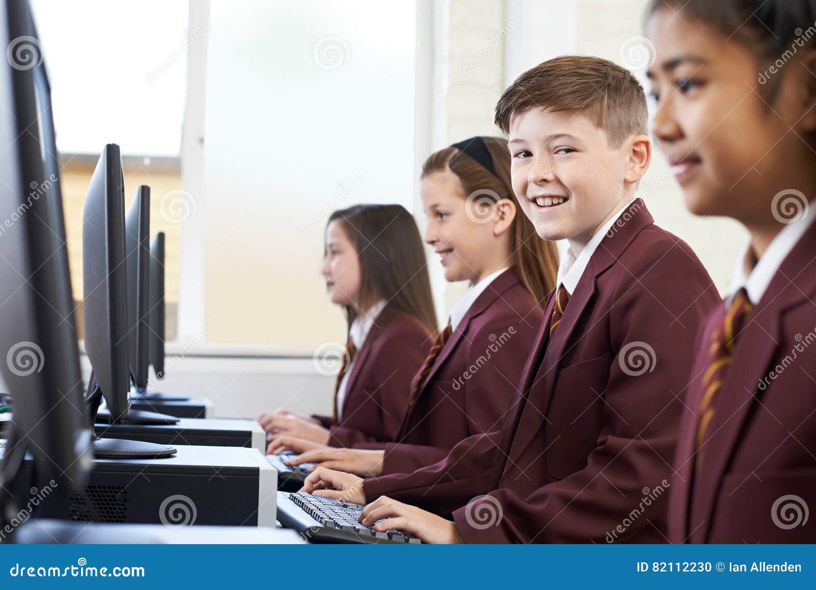 pupils wearing school uniform in computer class