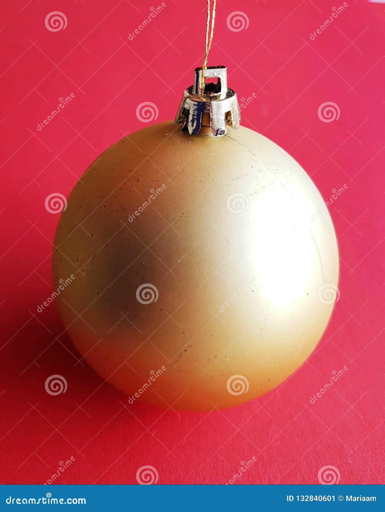 pure and clean christmas ball over festive redish background. merry xmas decoration.