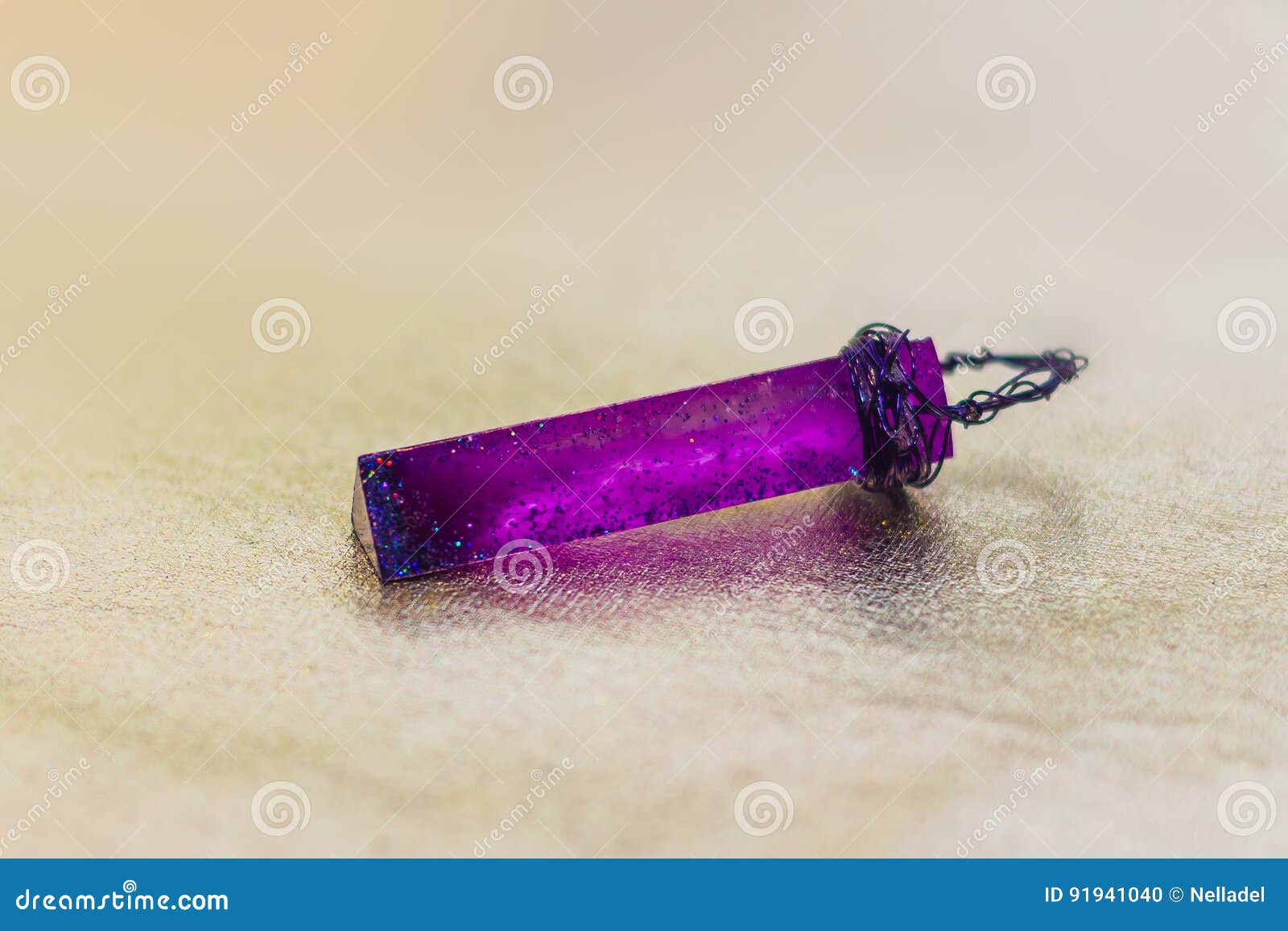 purple crystal made of epoxy resin and glitters close-up