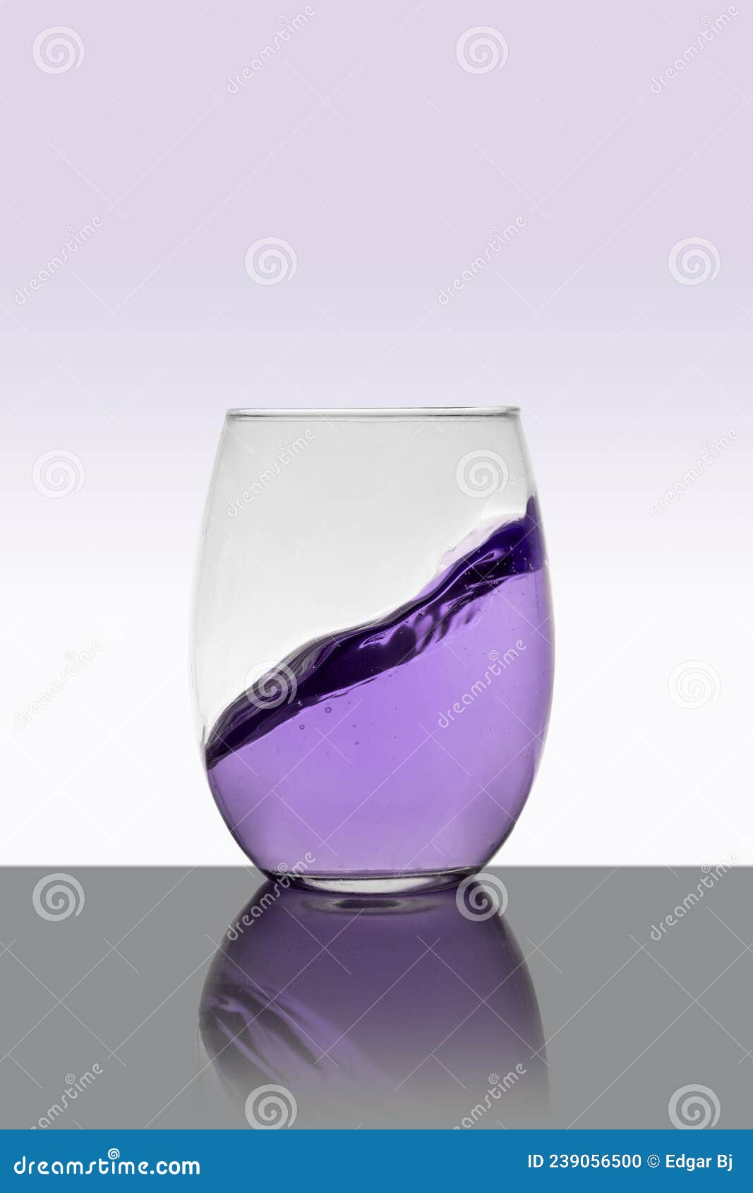 Purple Drink in Glass with a Splash and White Background Stock Photo