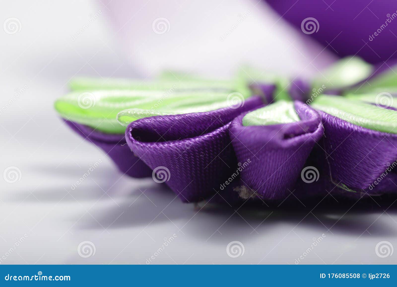 purple flower broche that made of satin ribbon