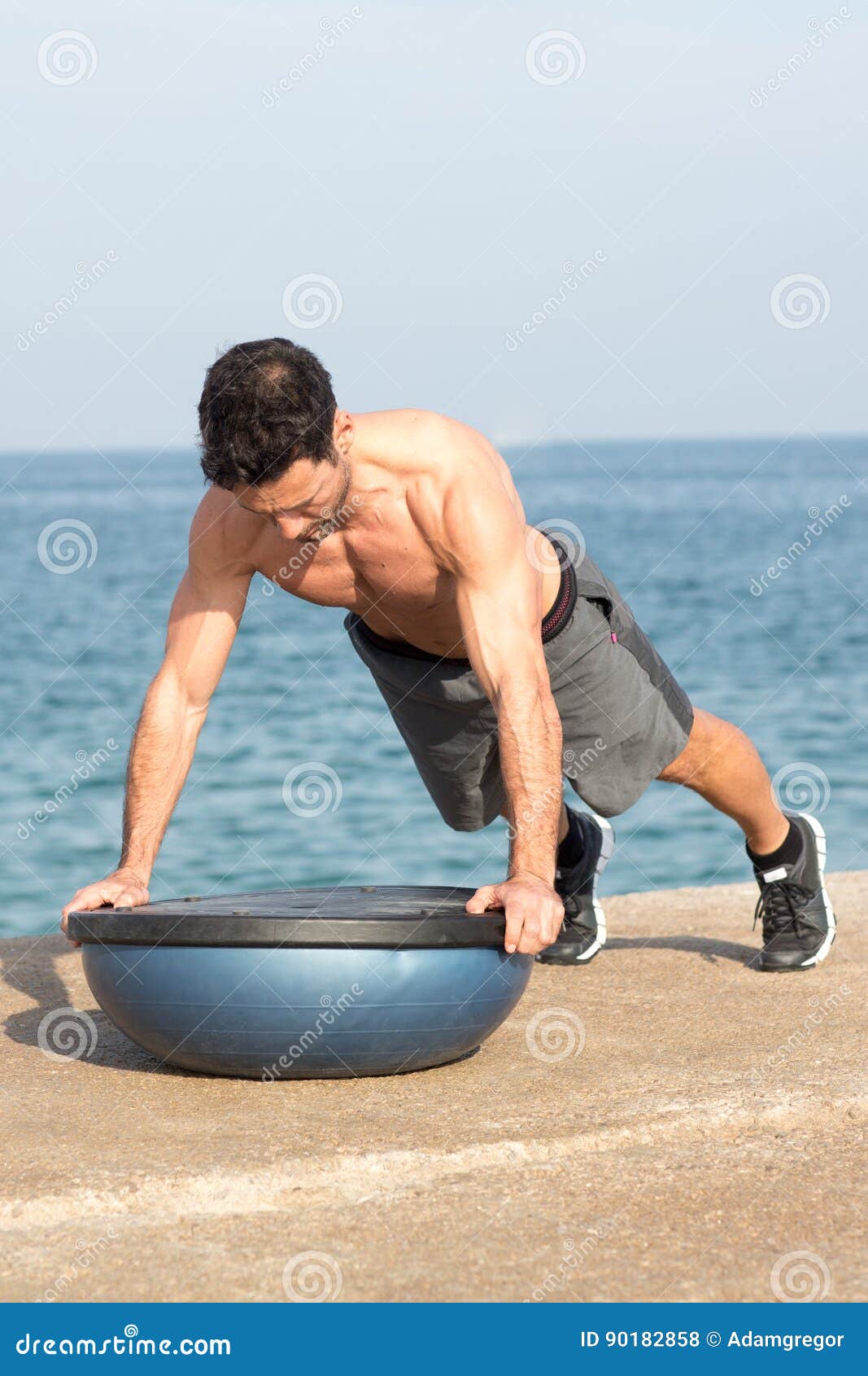 Push ups on a bosu balance stock photo. Image of training 90182858
