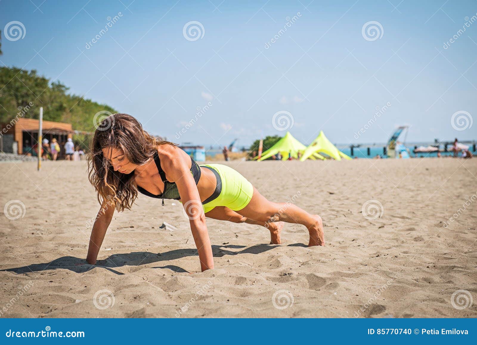 Push-ups fitness woman doing pushups outside on beach. Fit female sport model girl training crossfit outdoors.
